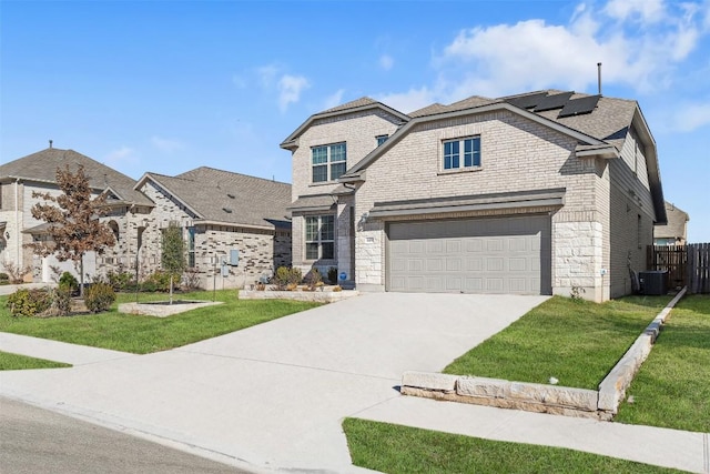 view of front of house with fence, concrete driveway, a front yard, brick siding, and solar panels