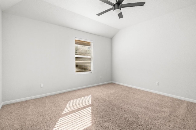 unfurnished room with baseboards, carpet floors, and vaulted ceiling