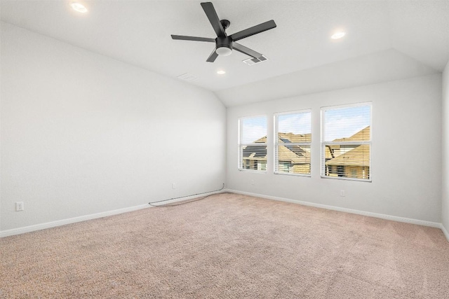 spare room featuring vaulted ceiling, baseboards, and visible vents