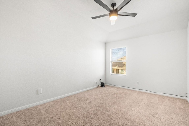 empty room featuring baseboards, light carpet, a ceiling fan, and vaulted ceiling