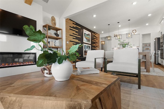 1913 Summercrest Blvd, Georgetown, TX 78626 - dining space with recessed lighting, a glass covered fireplace, and light wood-type flooring