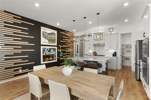 dining area with recessed lighting and light wood-type flooring