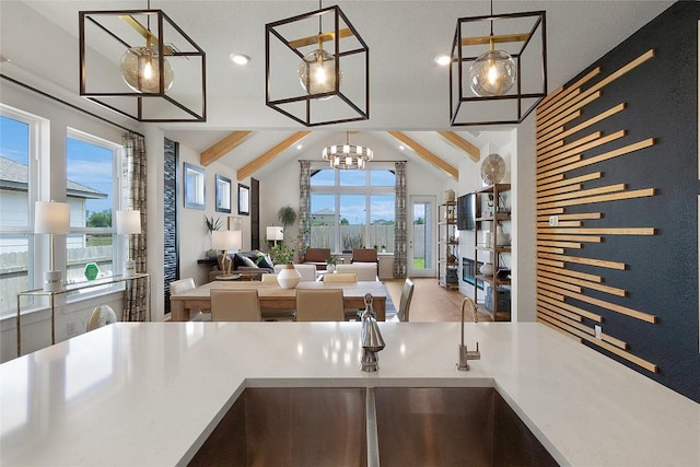 kitchen featuring lofted ceiling with beams, decorative light fixtures, recessed lighting, and open floor plan