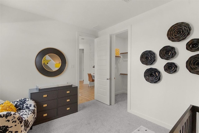 bedroom featuring a spacious closet and carpet