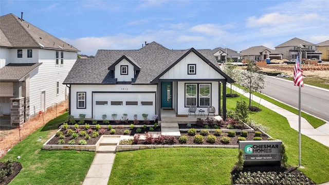 view of front of property featuring a front yard, a garden, fence, and roof with shingles