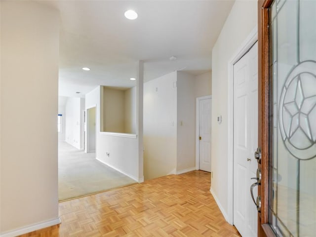 foyer with recessed lighting and baseboards