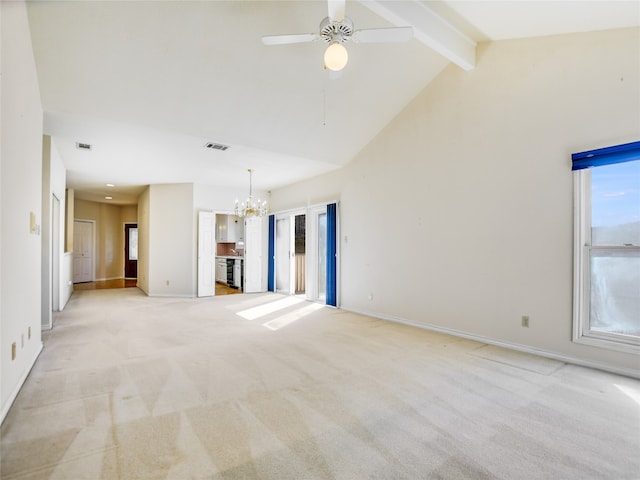 unfurnished living room with beamed ceiling, light colored carpet, visible vents, and baseboards