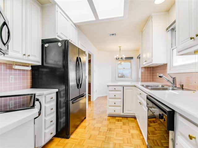 kitchen featuring white cabinetry, black appliances, light countertops, and a sink