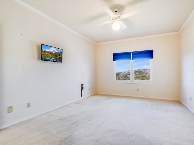 unfurnished room featuring baseboards, light colored carpet, ceiling fan, and crown molding