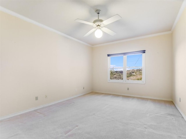 unfurnished room with crown molding, a ceiling fan, light colored carpet, and baseboards