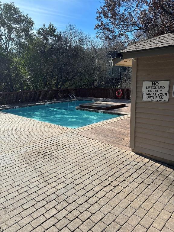 pool featuring a patio area and fence