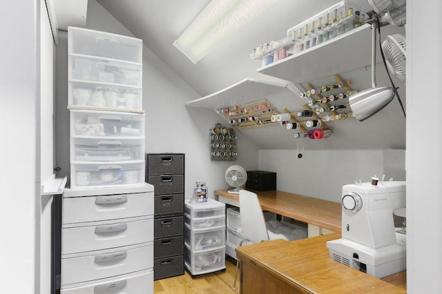 office space with lofted ceiling and light wood-type flooring