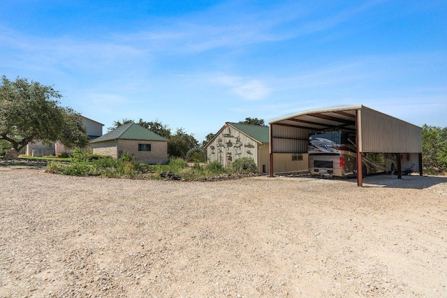 exterior space with a detached carport and driveway