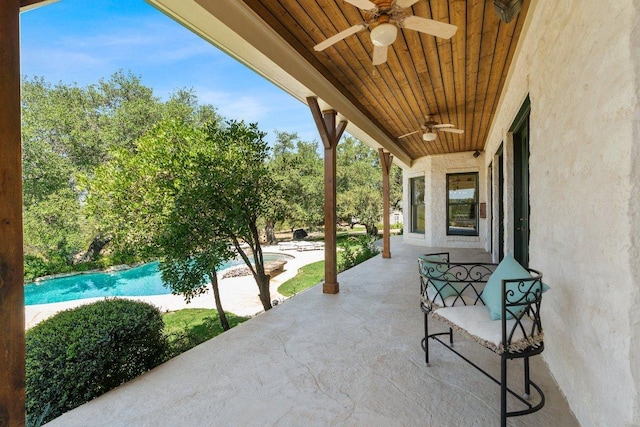 view of patio featuring an outdoor pool and ceiling fan