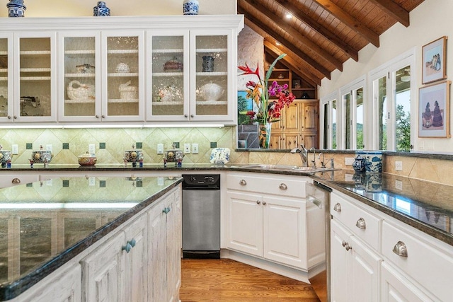 kitchen featuring tasteful backsplash, wooden ceiling, vaulted ceiling with beams, and white cabinetry