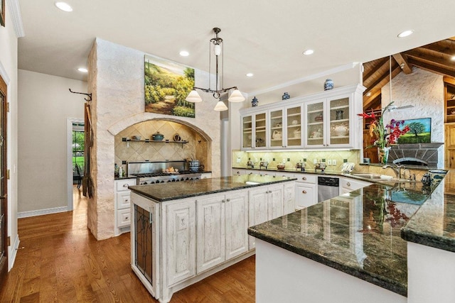 kitchen with decorative backsplash, dark wood-style floors, a fireplace, and white cabinets