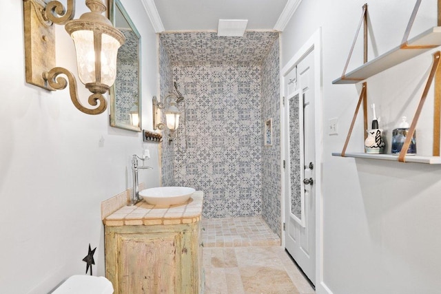 full bathroom featuring vanity, crown molding, toilet, and a tile shower