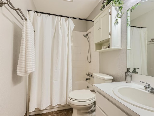 full bathroom with vanity, shower / tub combo, toilet, and a textured wall