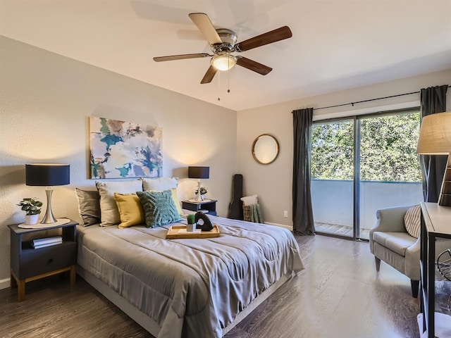 bedroom featuring access to exterior, wood finished floors, and baseboards