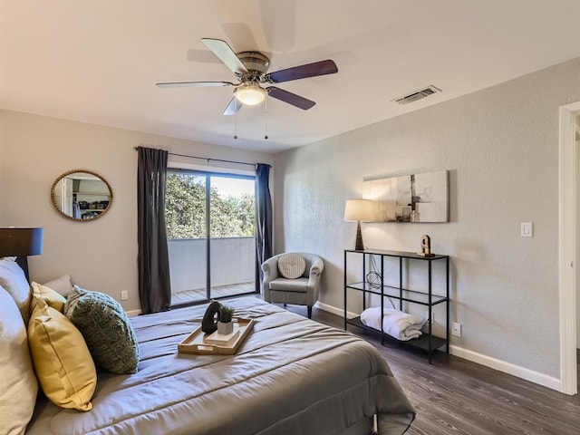 bedroom with access to exterior, visible vents, dark wood-type flooring, baseboards, and a textured wall