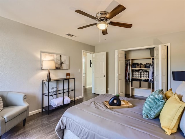 bedroom with visible vents, wood finished floors, a closet, baseboards, and ceiling fan