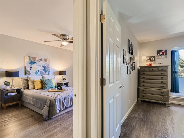 bedroom featuring dark wood-style floors, ceiling fan, and baseboards