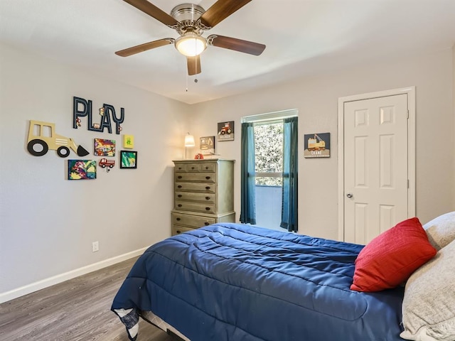 bedroom featuring wood finished floors, baseboards, and ceiling fan