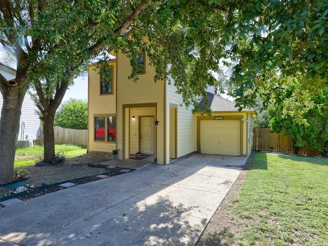 view of front of house featuring a front yard, an attached garage, driveway, and fence