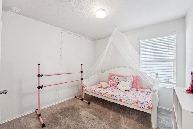 bedroom featuring baseboards, carpet, and a textured ceiling