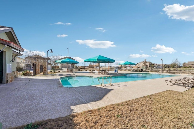 pool featuring a patio and fence