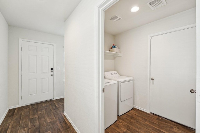 laundry room featuring dark wood finished floors, laundry area, separate washer and dryer, and visible vents