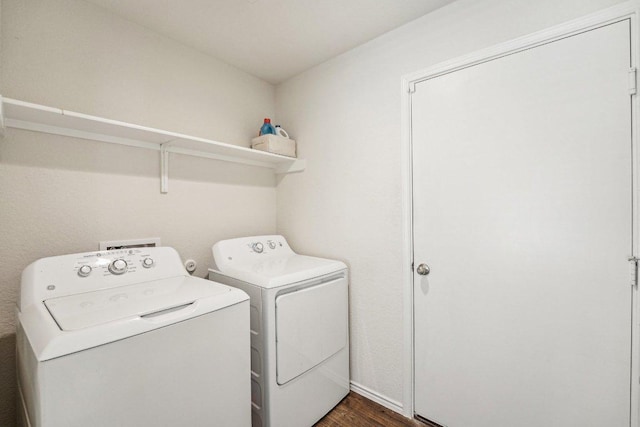 laundry area with dark wood-style flooring, laundry area, and washing machine and clothes dryer