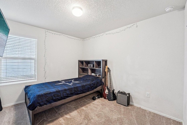 carpeted bedroom featuring a textured ceiling