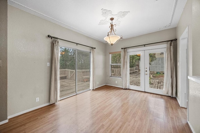 1100 Silverton Ct, Austin, TX 78753 - unfurnished room with french doors, wood finished floors, baseboards, and crown molding