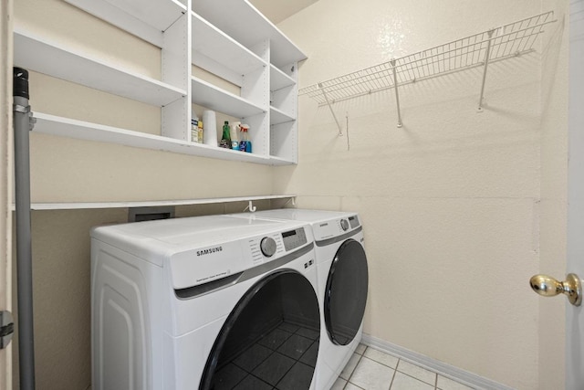 1100 Silverton Ct, Austin, TX 78753 - laundry area with washing machine and dryer, light tile patterned floors, and baseboards