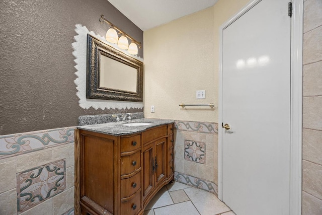 1100 Silverton Ct, Austin, TX 78753 - bathroom with tile walls, wainscoting, vanity, and tile patterned floors