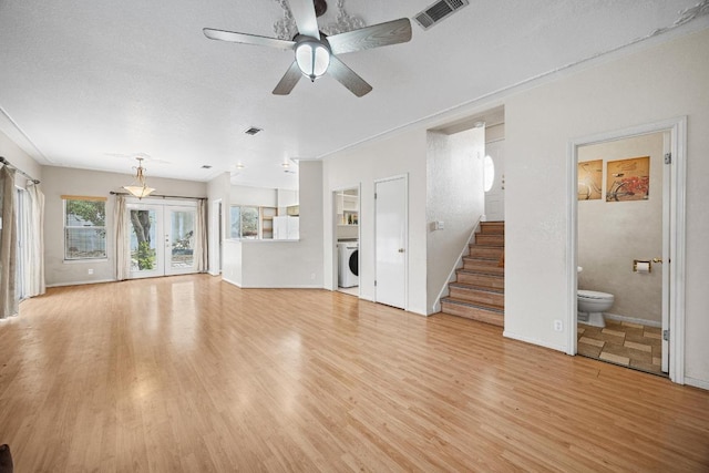1100 Silverton Ct, Austin, TX 78753 - unfurnished living room with washer / dryer, light wood-type flooring, ceiling fan, stairs, and baseboards