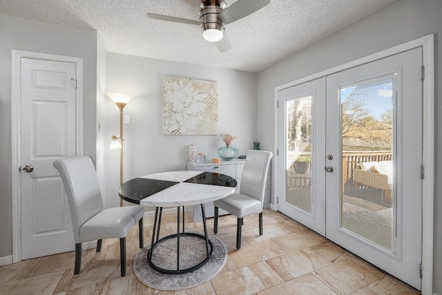 dining room with french doors, a textured ceiling, and ceiling fan