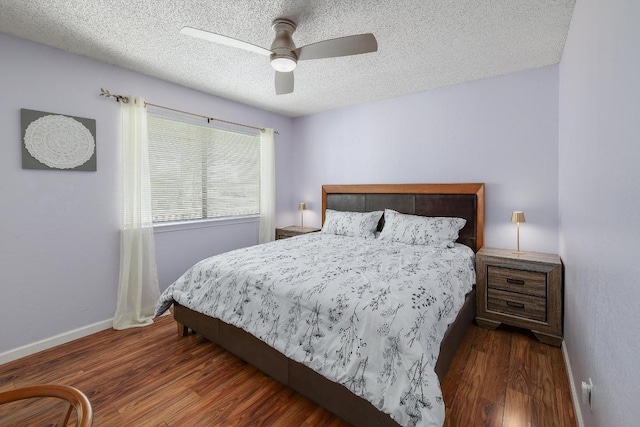 bedroom featuring a textured ceiling, a ceiling fan, baseboards, and wood finished floors