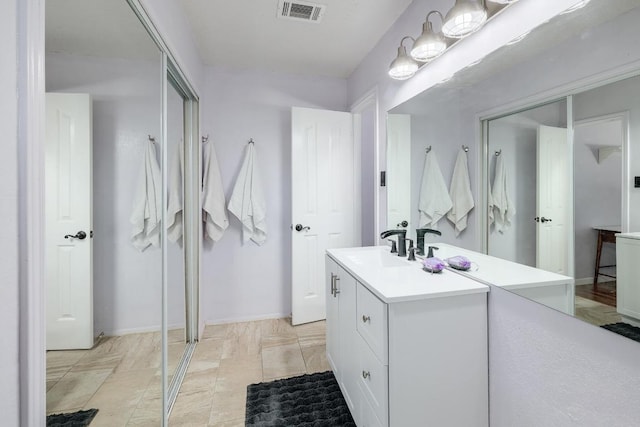 bathroom featuring visible vents and vanity