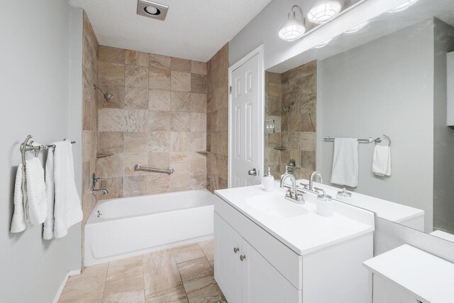 bathroom featuring vanity, bathtub / shower combination, and a textured ceiling