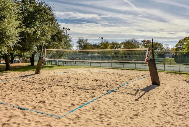 surrounding community with volleyball court and fence