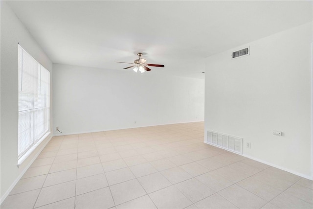 unfurnished room featuring visible vents, baseboards, and a ceiling fan