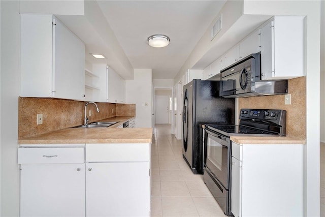 kitchen featuring black appliances, a sink, open shelves, light countertops, and light tile patterned floors