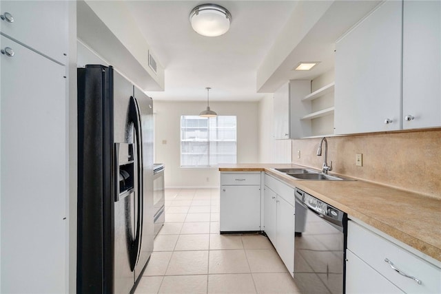 kitchen featuring a sink, fridge with ice dispenser, light tile patterned floors, dishwashing machine, and open shelves