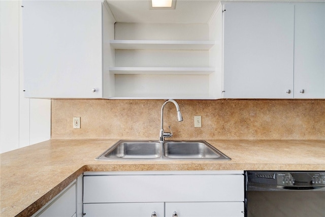 kitchen with open shelves, white cabinetry, black dishwasher, and a sink