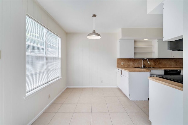 kitchen with white cabinetry, open shelves, light tile patterned floors, and backsplash