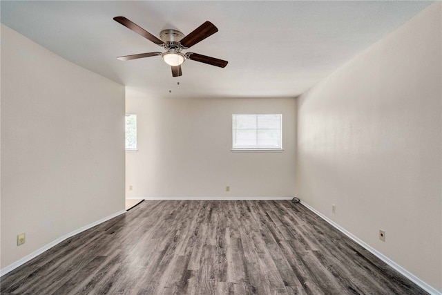 unfurnished room featuring ceiling fan, baseboards, and wood finished floors