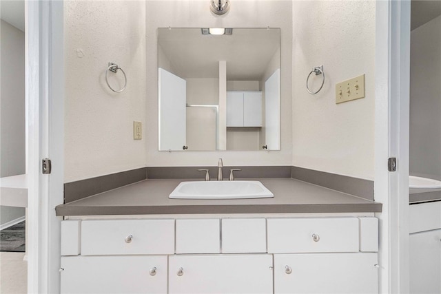 bathroom featuring vanity and a shower with shower door