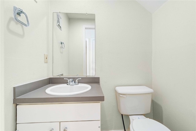 bathroom featuring toilet and vanity